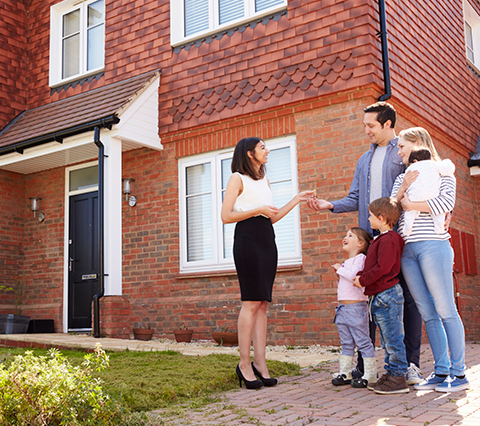 Family Getting Handed The Keys To Their New Home After Finalizing A Closing