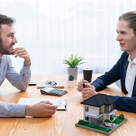 Two People Discussing Over Real Estate
