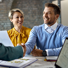 Men Shaking Hands and a Woman Smiling