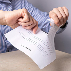 Two Hands Tearing a Document