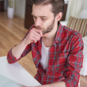 A Man Thinking over a Piece of Paper