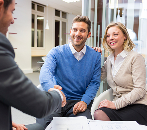 Man shaking hands with title officer after finalizing residential title services