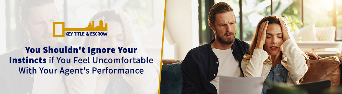 A Worried Couple Looking at Documents and a Laptop