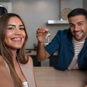 A Woman and a Man Holding a House Key