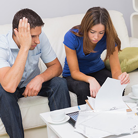 A Worried Couple Looking a Papers